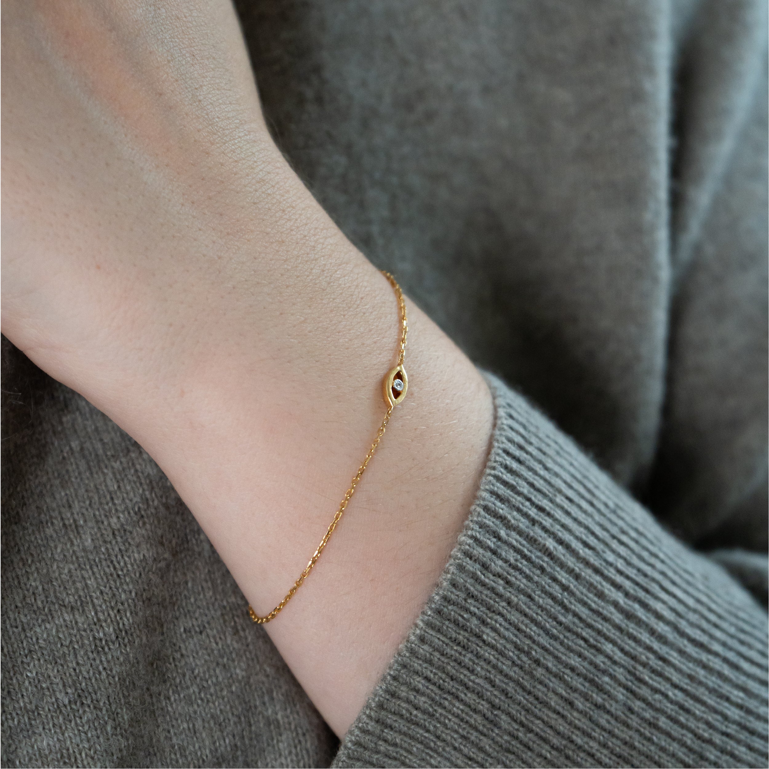 Evil Eye armbånd i 18 kt guld med diamant – vist på håndled
